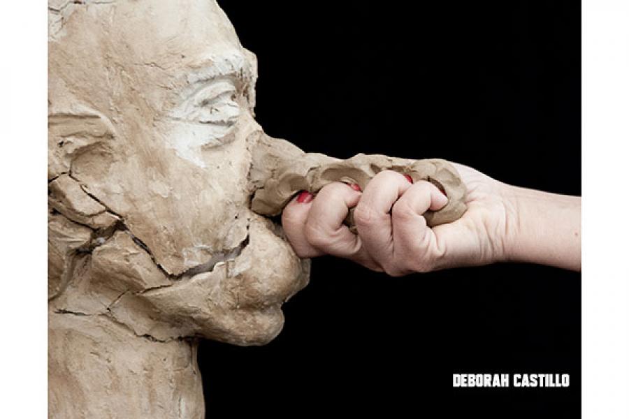  Hand grasping clay nose of bust of a man