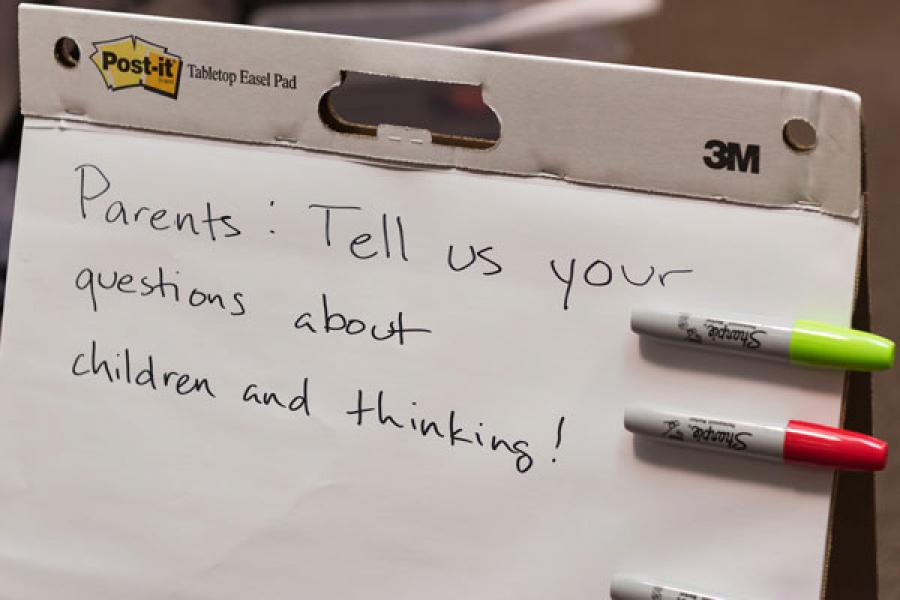 Easel pad with invitation written on it to parents to write their questions.