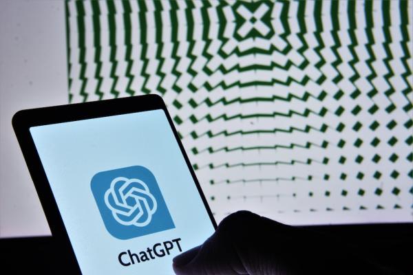 Small screen shows ChatGPT/OpenAI logo with a large screen showing a pattern in the background