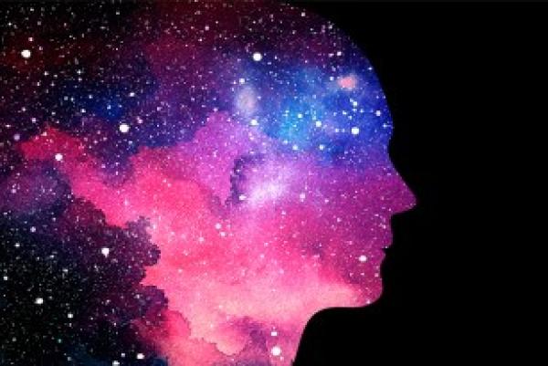 Fantastilcal ilustration showing a silhouette of a human face in pink, purple and blue celestial light populated by stars