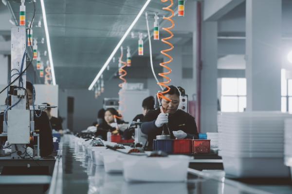 Line of people working in a factory