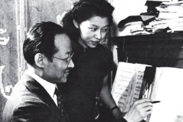 two people looking at sheet music that's sitting on a piano