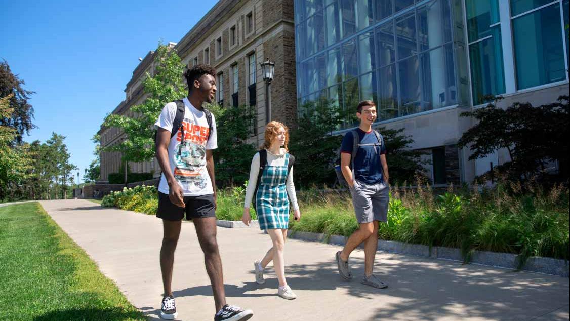 Students in the Pre-Collegiate Summer Scholars Program walking past the Physical Sciences Building