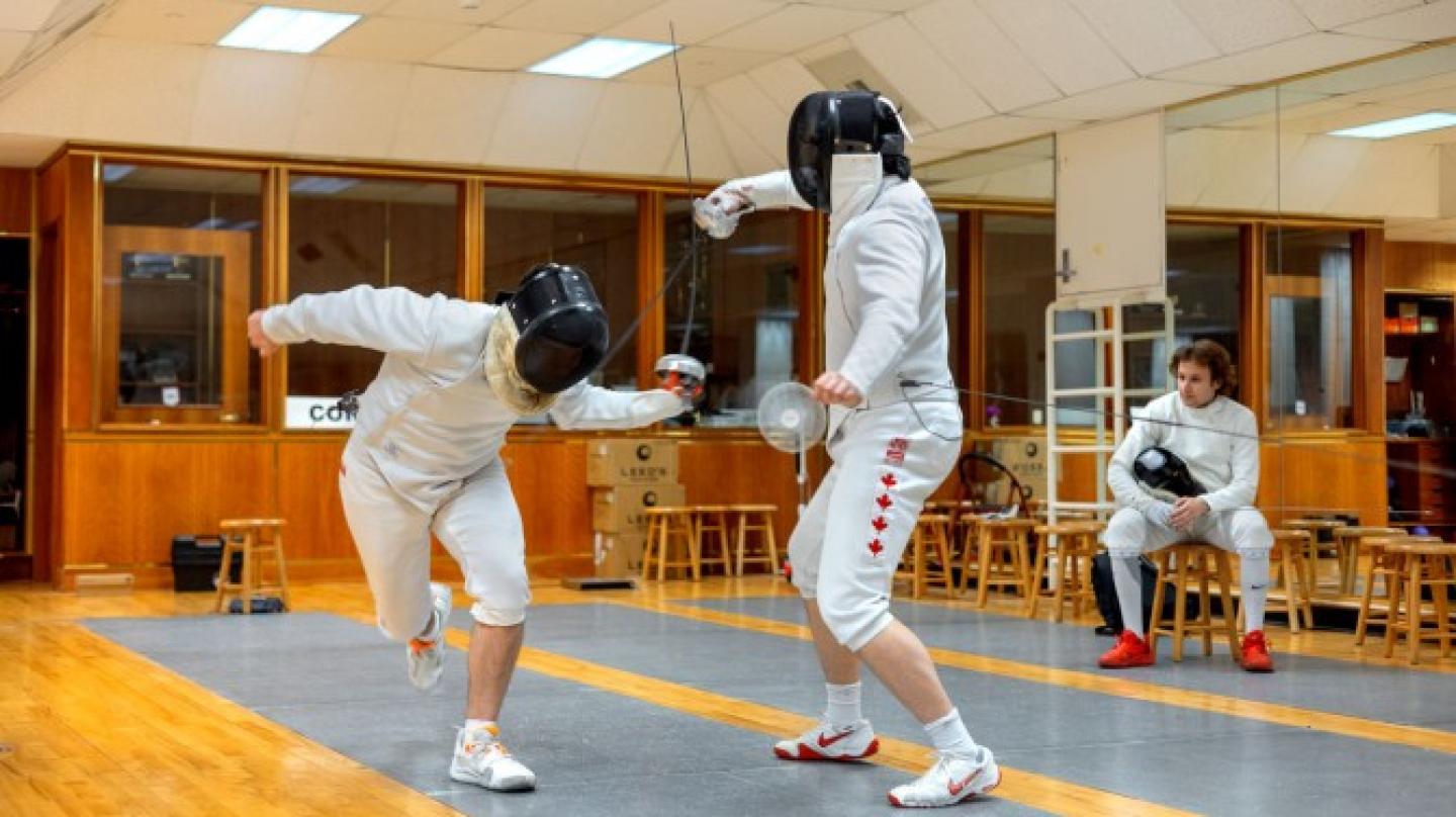 Two people, fencing