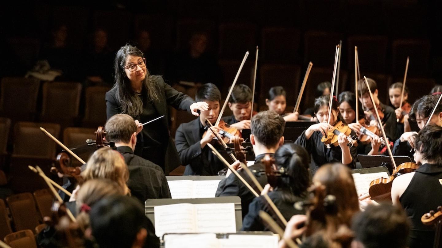 A conductor directs an orchestra