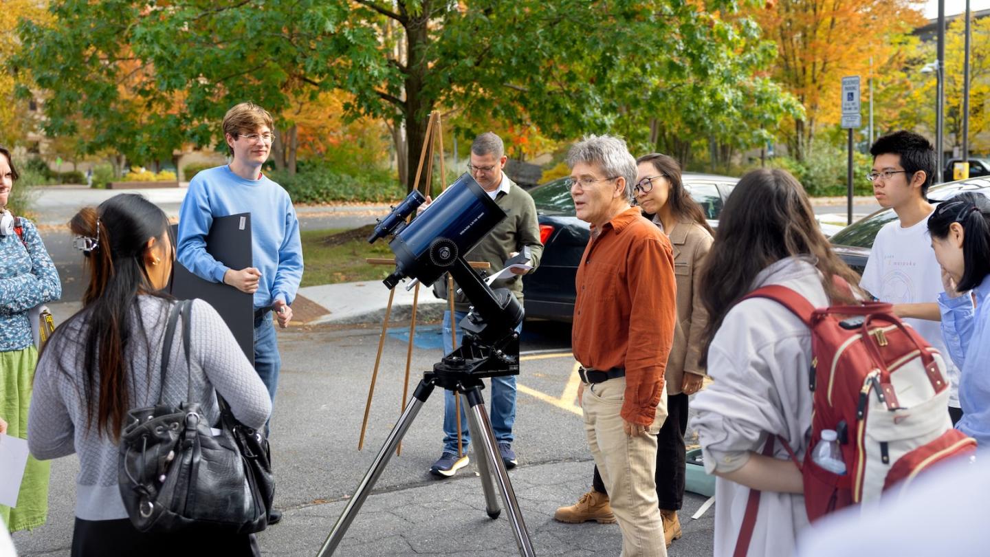 Gordon Stacey and astronomy students viewing sun spots outdoors